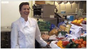 Woman chef at counter full of produce