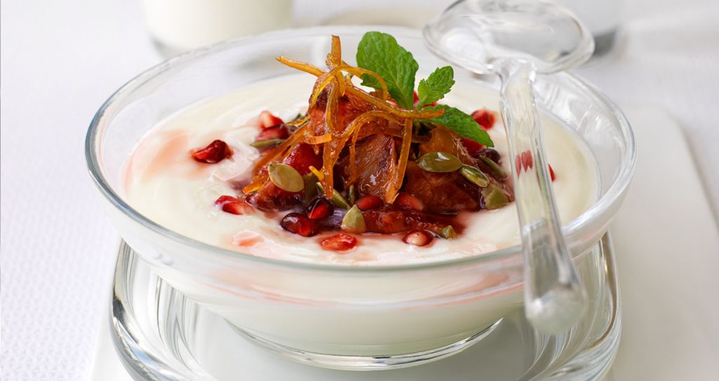 a pot of Greek yogurt with pomegranate and blood orange